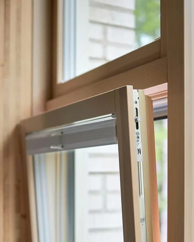 Close-up of a wooden window partially open.