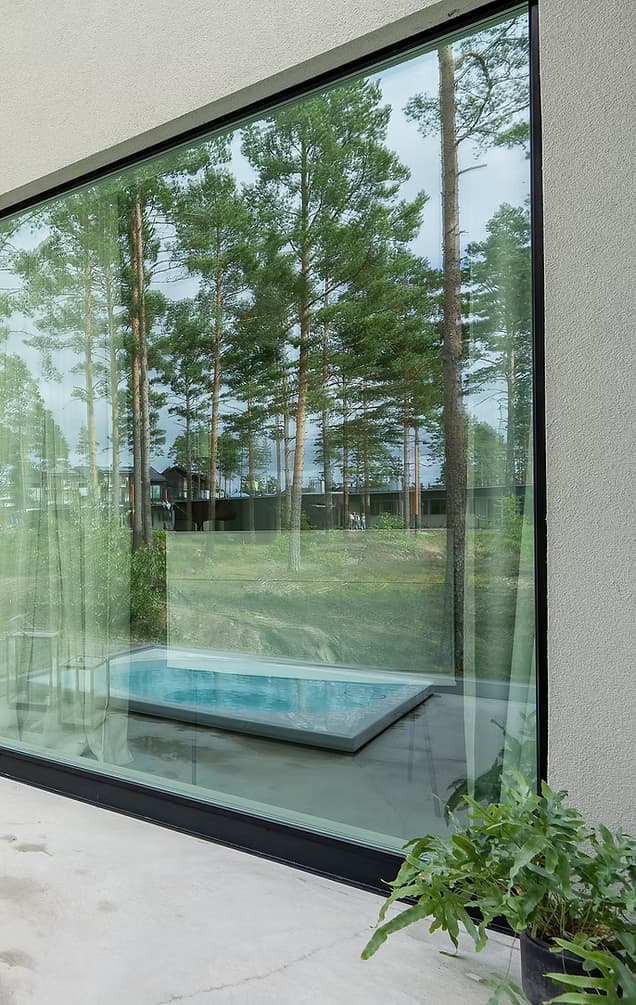 Backyard with large glass doors and a pool.