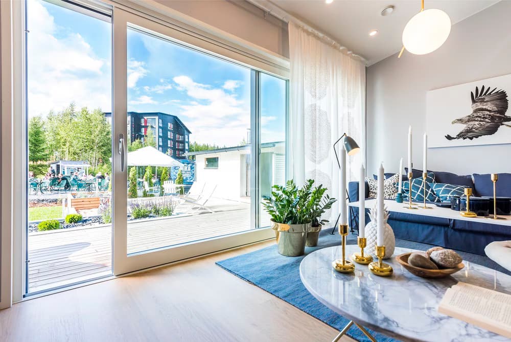 Contemporary living room with large windows and outdoor deck access