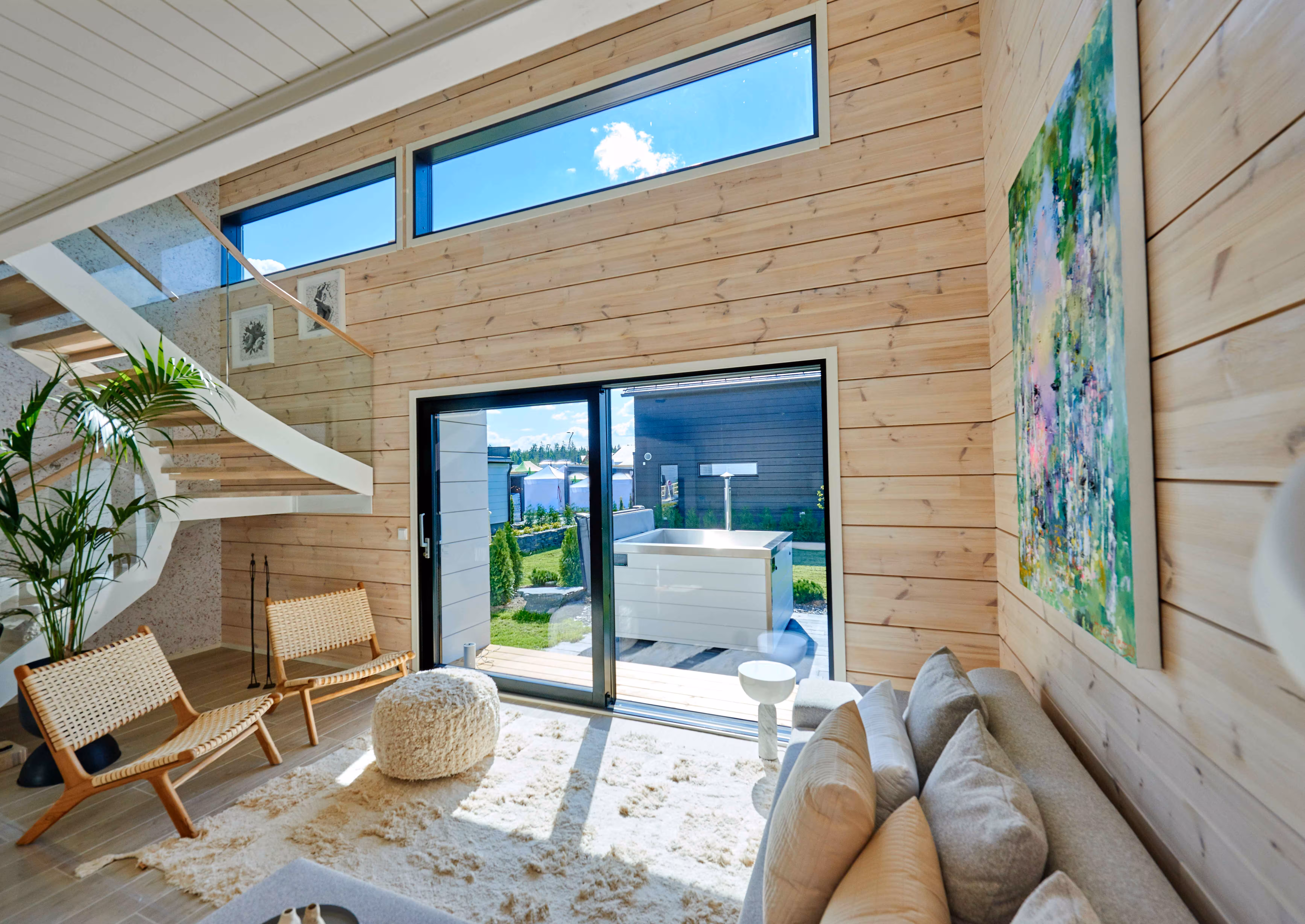 Wood-paneled living room with skylight and outdoor hot tub access
