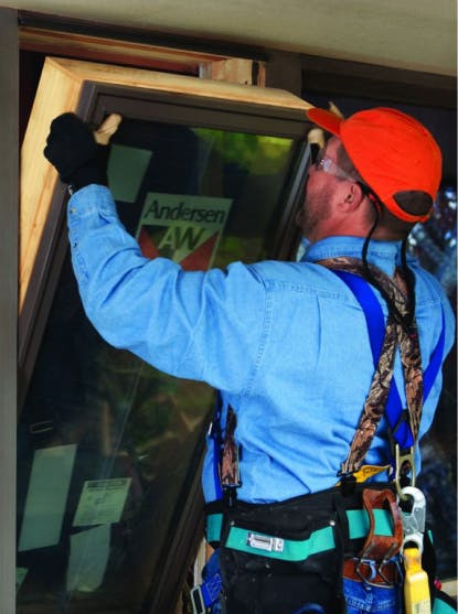 Worker installing a window