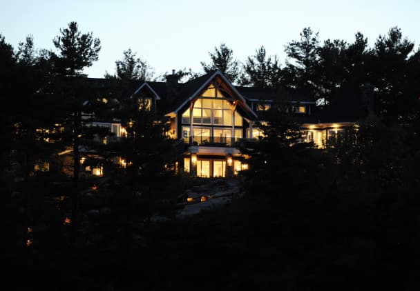 A well lit house seen at night from outdoors